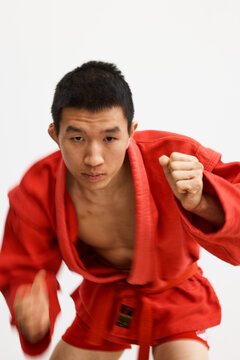 Young martial artist practices training techniques in a dojo