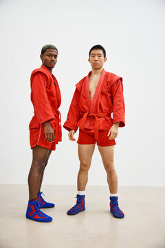 Training session with martial artists in red uniforms indoors