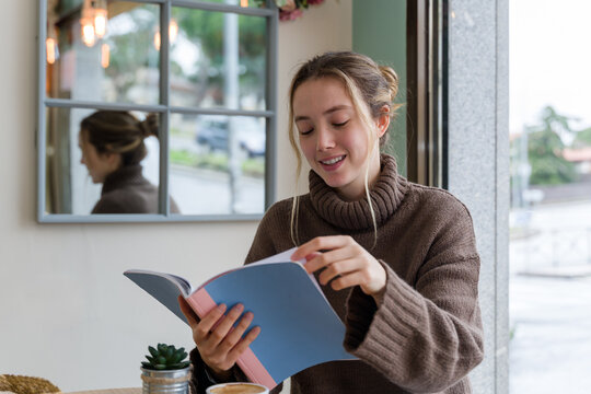 woman reading a book in a coffee shop