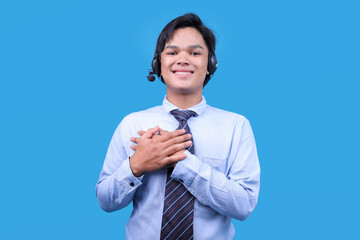 Professional customer care with hands on chest, showing gratitude and kindness over blue backdrop