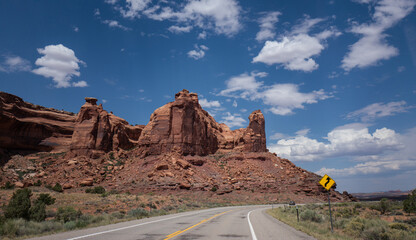 A winding dirt road cuts through the desert landscape of Canyonlands