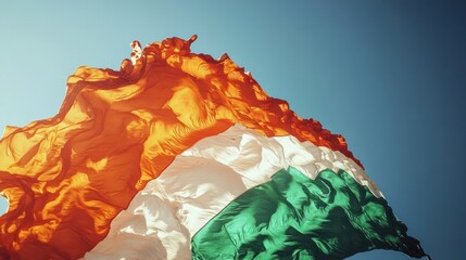 Obraz premium Majestic Ivory Coast Flag billowing in the wind, a vibrant display of national pride.