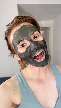 A woman in a mud mask, selfie photo