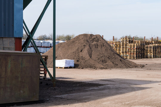 Large pile of aggregate and pallets outside