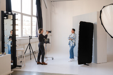 Photographer Capturing Model in Bright Studio
