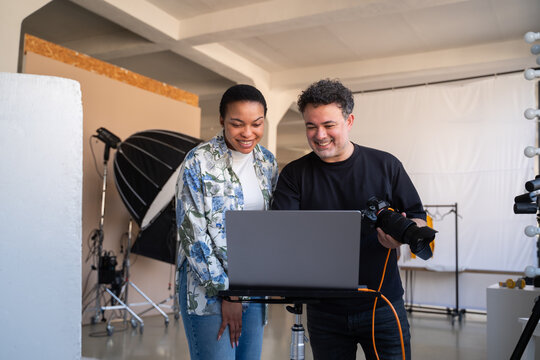 Photographer Showing Model Results Of Photoshoot In Studio