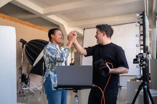 Photographer And Model Excited About Great Results Of Photoshoot