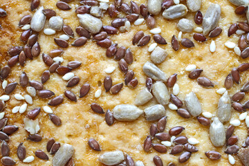 Close-up of the surface of a bakery product with seeds and grains. Natural healthy food.