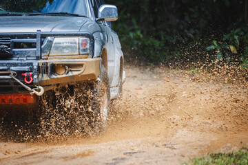 Off-road vehicles driving on muddy tracks. Mud and water splash in off-road racing. Offroad car expedition