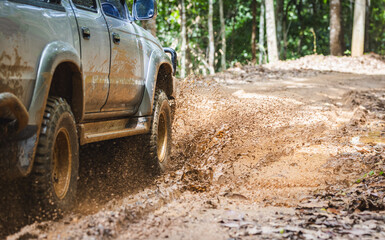 Off-road vehicles driving on muddy tracks. Mud and water splash in off-road racing. Offroad car expedition