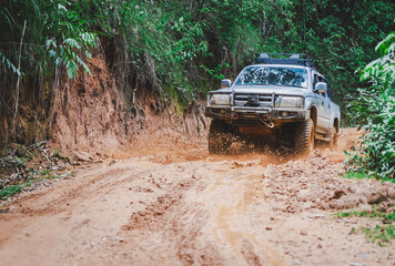 Off-road vehicles driving on muddy tracks. Mud and water splash in off-road racing. Offroad car expedition