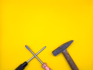 Set of various construction tools. Tools for home repair. Work at a construction site. On a yellow background. Flat lay. Top view, copy space.