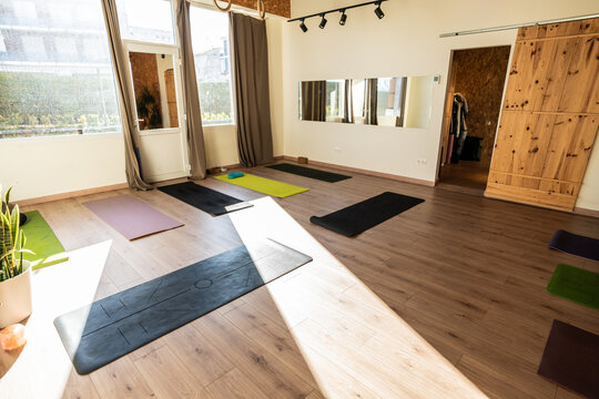 Yoga mats arranged on the floor in an empty studio