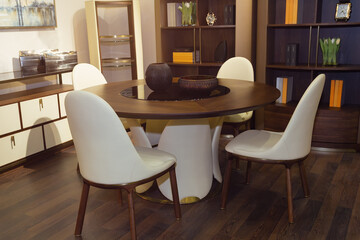 A modern living room with a round table and chairs