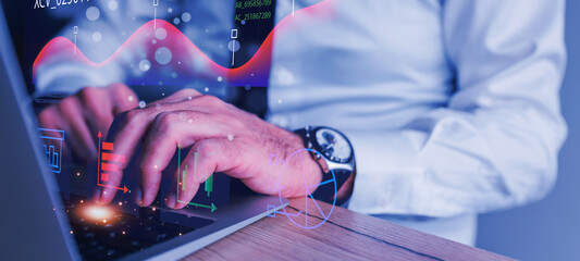 Close-up view of a person's hands typing on a laptop, with dynamic data visualizations and graphs overlaid on the screen, suggesting data analysis, market trends, or stock trading.