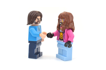 Fototapeta premium Lego minifigures of Garrett and Steve main character from video game Minecraft movie are shaking their hands. Editorial illustrative image of popular plastic toys.