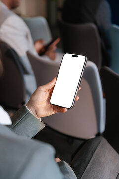 A woman uses a mobile phone with white screen