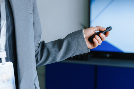A woman switches slides during a presentation in the office