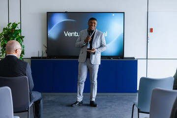 The man speaks into the microphone