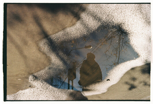 Reflection of a person in a puddle 