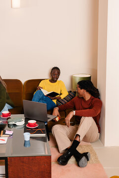 Colleagues reviewing paperwork on a laptop during a work meeting