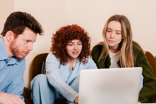 Small work team performing office tasks on an aptop