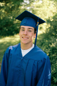 graduating  young man posing  for photos with diploma/certificate