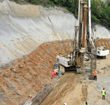 Construction Site Featuring Deep Excavation Machinery and Workers