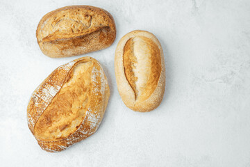 Freshly baked artisan bread loaves on a light background