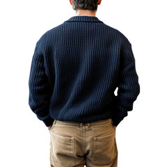 Back view of a man wearing textured blue sweater and casual tan pants standing against a plain setting