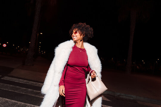 Elegant multiracial woman at night with fashion outfit