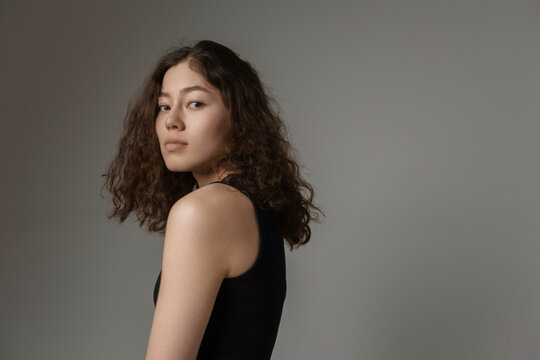 Fashion model posing in studio with gray background