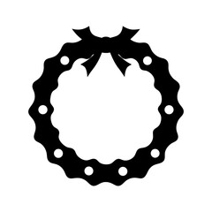 A simple black wreath made of chain with a decorative bow