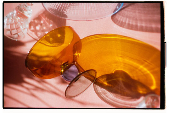 Colorful glassware arranged on a soft pink surface