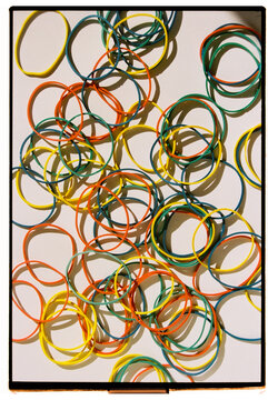 Colorful array of rubber bands scattered on a surface