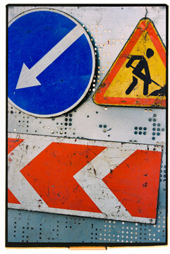 Traffic signs indicating road work and directional guidance