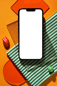 Flat lay with a blank screen of a smartphone on colorful background.