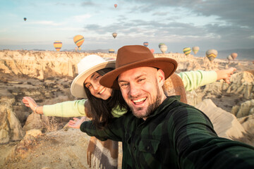 Happy young couple of tourists laughing taking selfie picture in Cappadocia, Turkey- Travel and...