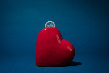 rolled-up condom on a porcelain heart