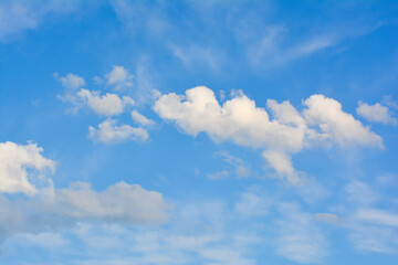 Blue sky background with white clouds. White clouds in the blue sky