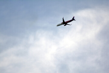 Airplane flying in the blue sky on a sunny day. Airplane flying in the blue sky with white clouds in the background