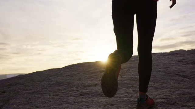 Jogger on mountain trail at sunset in Norway with peaceful and active feeling, Trolltunga