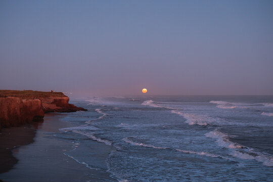 Full moon rising over the ocean in Mar del Plata
