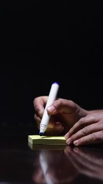 one hand writes a message at paper, you can