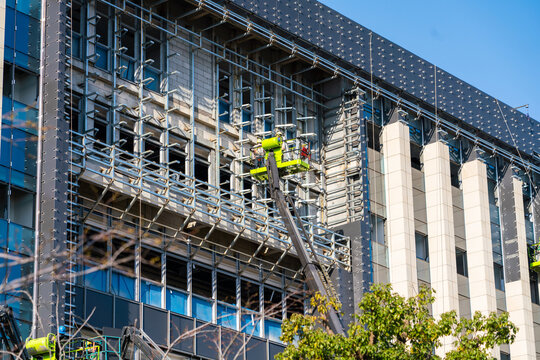 Construction Workers Installing Glass Windows on a Building