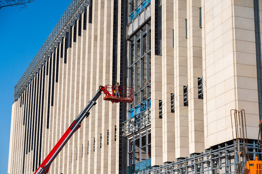 Construction Workers Installing Glass Windows on a Building