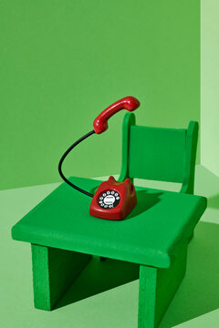 red telephone with the handset floating on the air