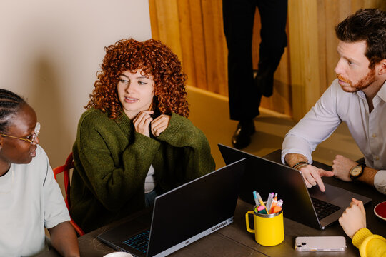 Meeting of a small creative team using computers to work