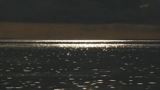 Footage of sea sparkles appearing on the sea surface with sunlight.