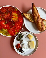 "An enchanting pink-themed dessert spread with vanilla-rose cupcakes, raspberry macarons, and strawberry panna cotta, artfully displayed on a blush marble surface with fresh peony accents."

